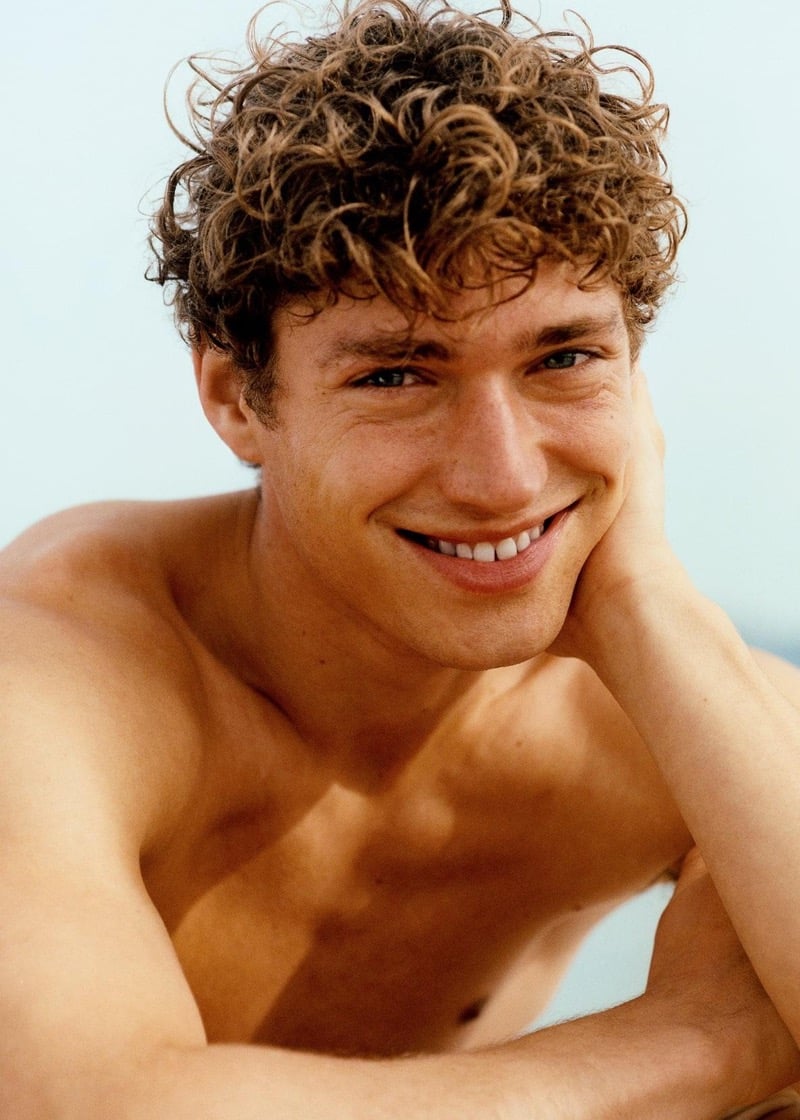 Valentin smiles in a sun-drenched close-up portrait for Massimo Dutti