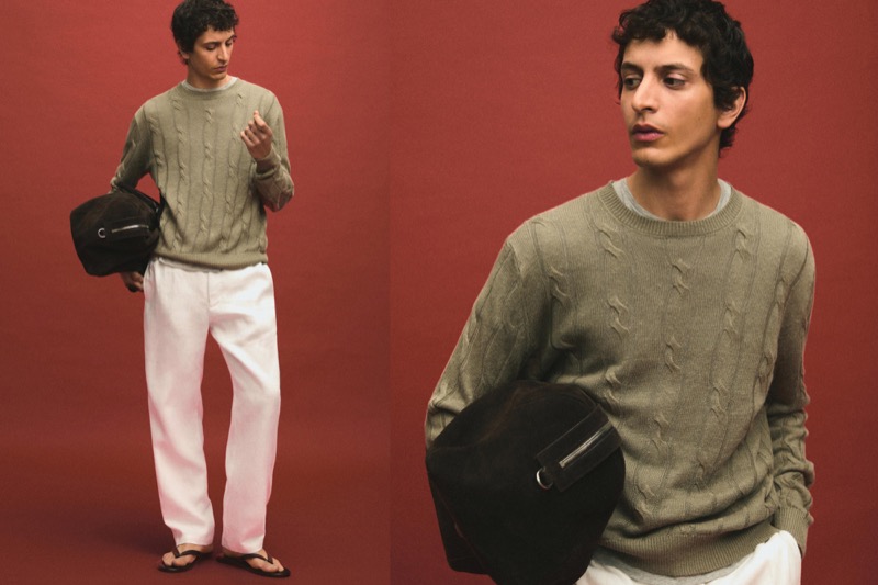 Takfarines wears a cable-knit sweater with white trousers and sandals