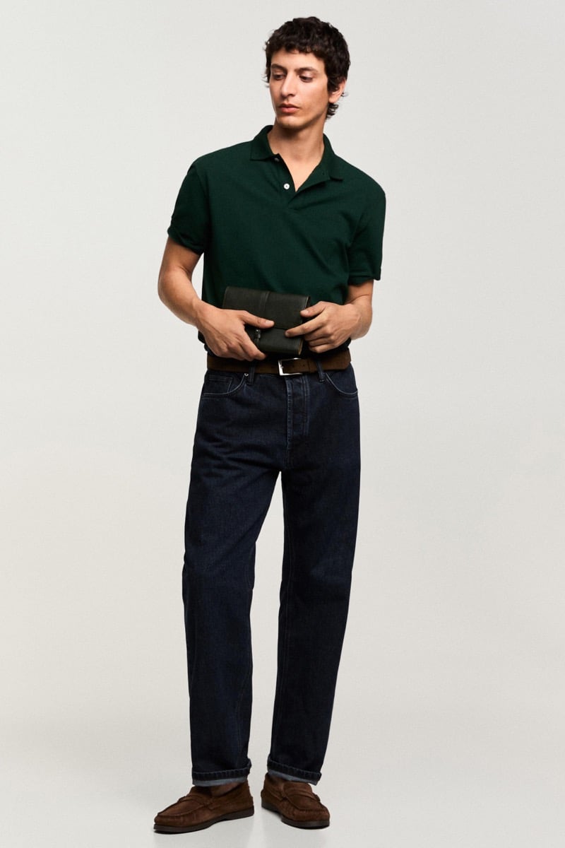 Takfarines wears a green polo shirt with dark jeans and suede loafers