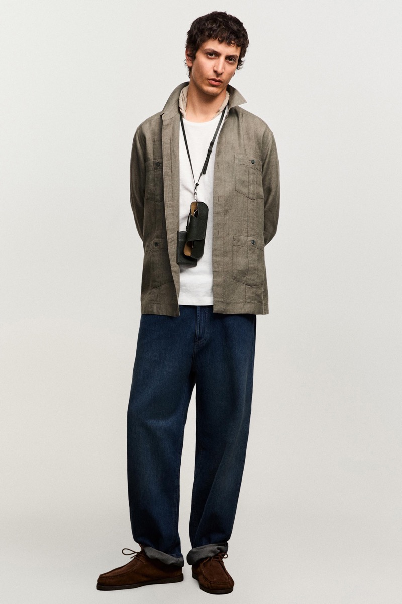 Takfarines wears an olive linen overshirt over a white tee with dark jeans