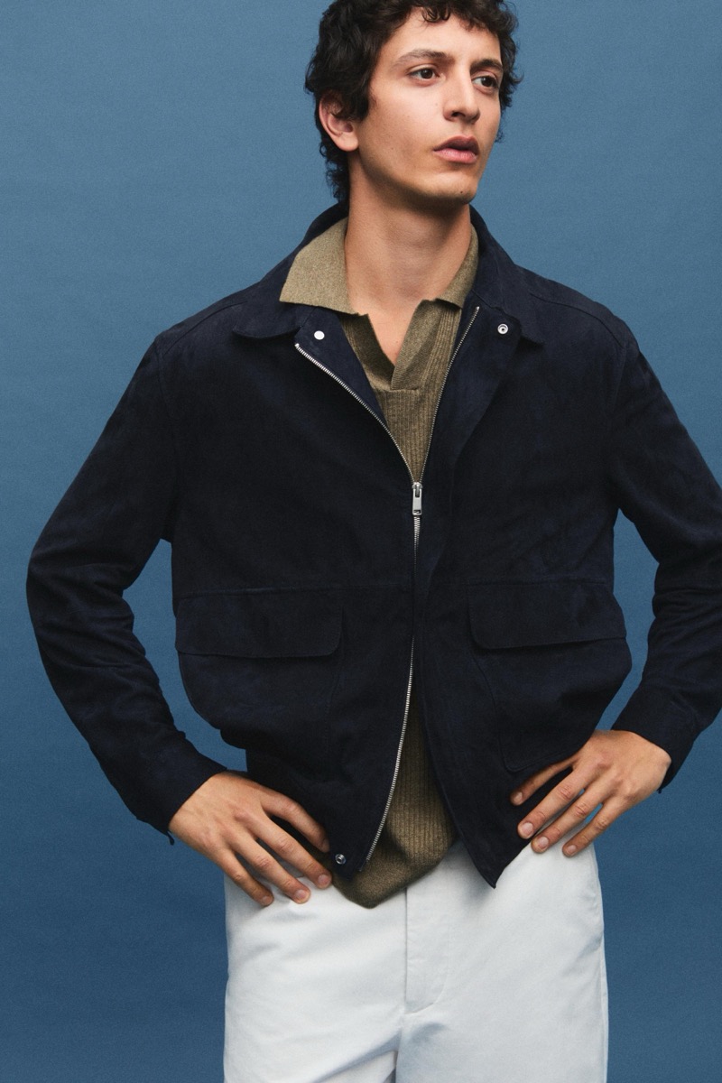 Takfarines wears a zip jacket over a knit polo