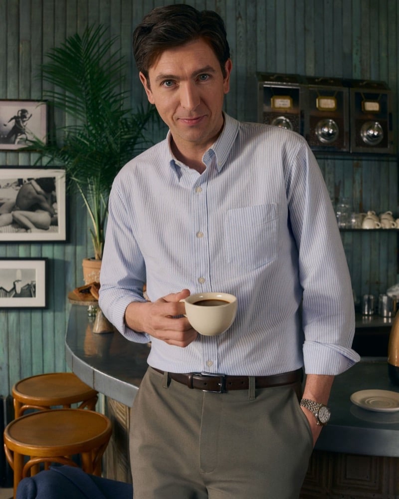Braun leans on the counter of a New York coffee shop in Bonobos chinos