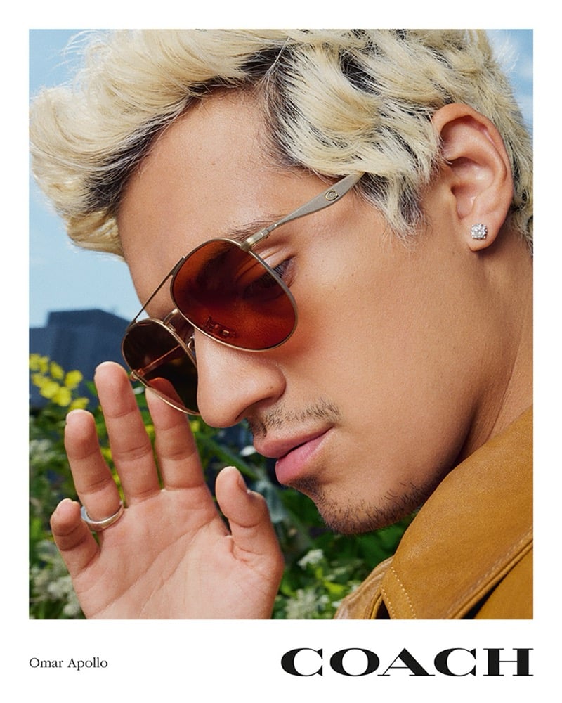 Side profile of Omar Apollo in Coach sunglasses