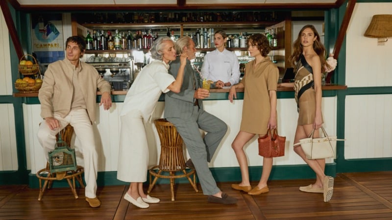The Tod's Vacanze Italiane cast gathers at a Campari beach bar, wearing Gommino loafers and carrying the brand's leather bags