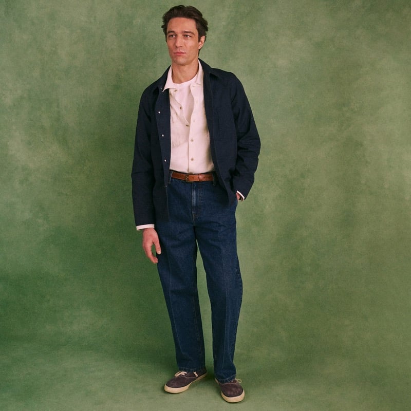 Model wears the Wallace & Barnes Creased Slant-Pocket Jean in Japanese Selvedge Denim with a navy chore jacket and suede shoes