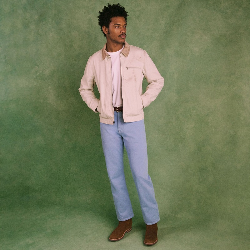 Model wears the Wallace & Barnes Straight-Fit Jean in Cotton Twill in light blue with a canvas work jacket and suede Chelsea boots