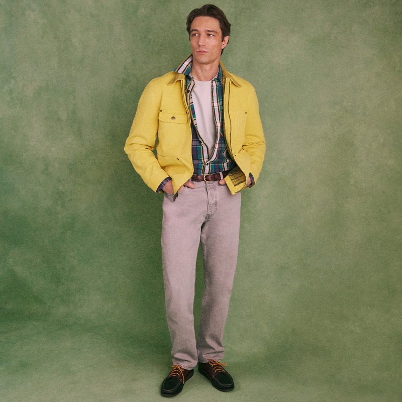 Model wears the Wallace & Barnes Straight-Fit Jean and a yellow zip-front chore jacket with plaid shirt and lace-up boots