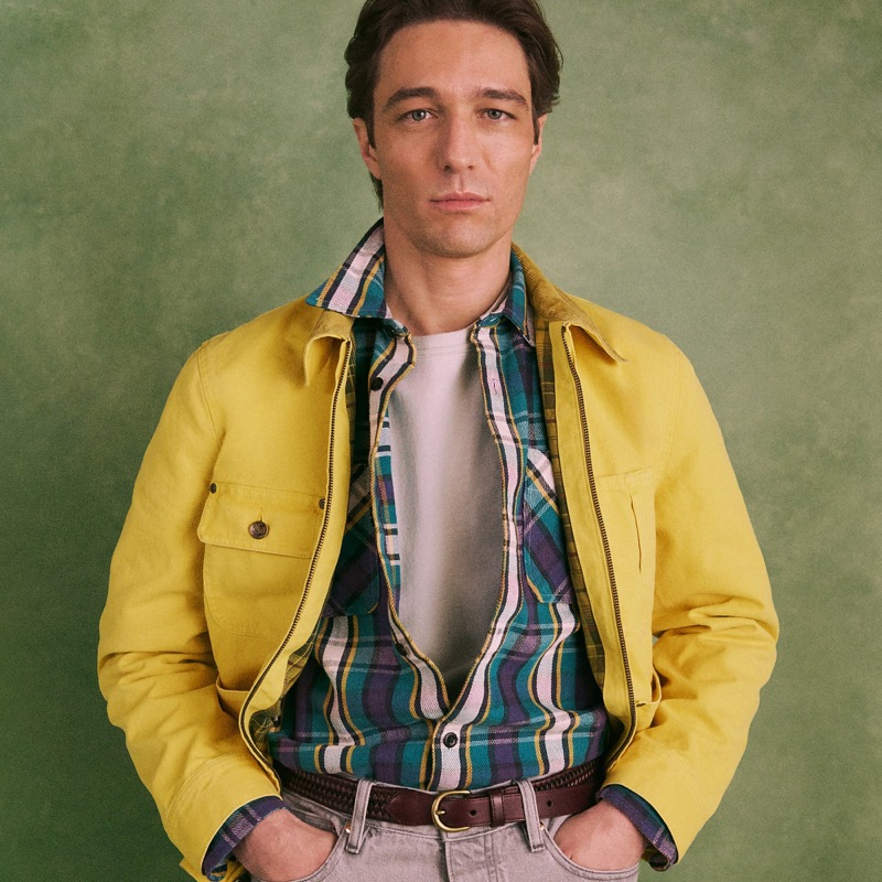 Model wears the Wallace & Barnes Zip-Front Chore Jacket in yellow over a plaid shirt and white tee