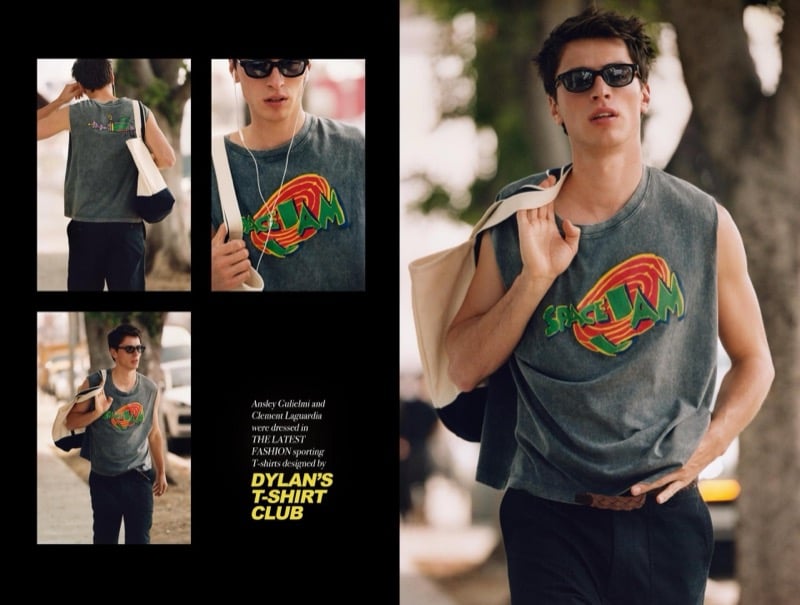 Clement wears a washed-grey Space Jam sleeveless T-shirt with dark trousers, a canvas tote bag on his shoulder, and black rectangular sunglasses