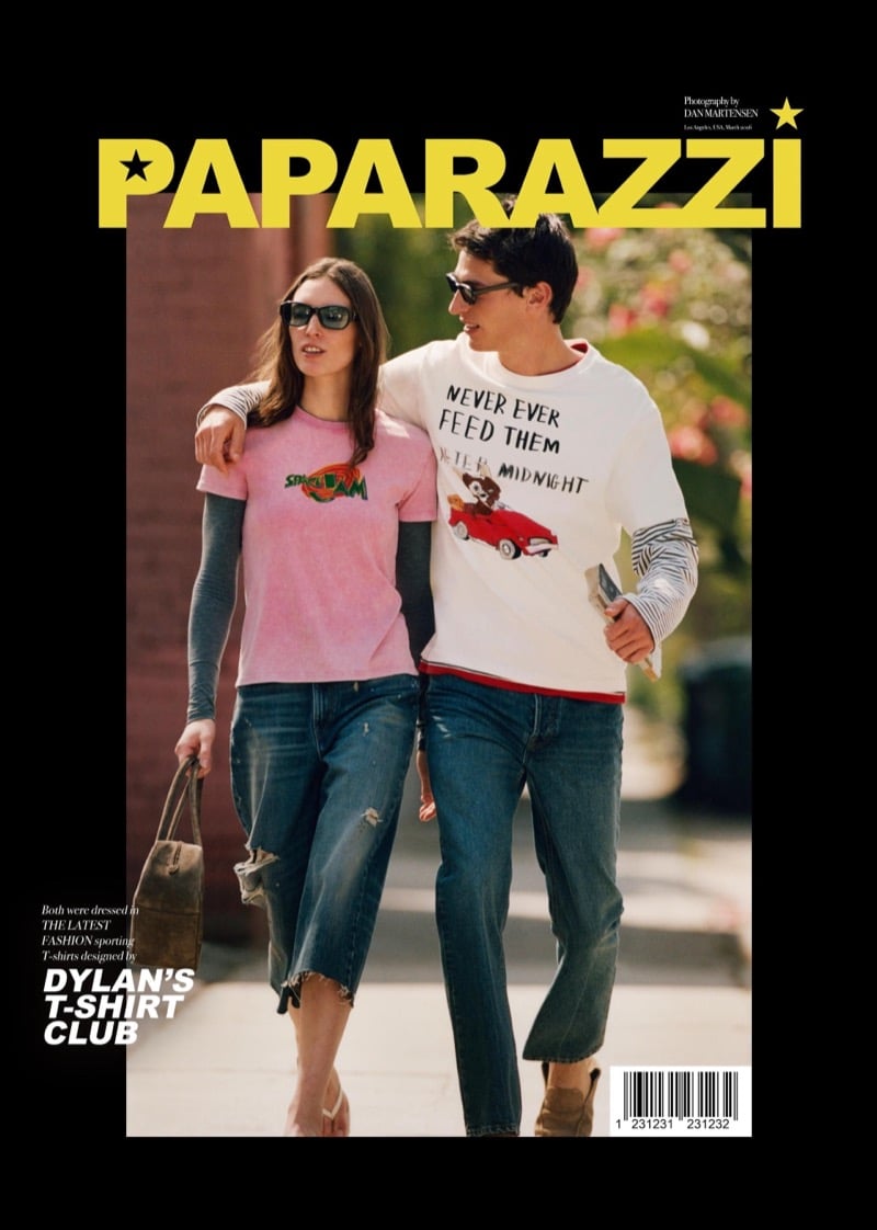 Ansley and Clement walk together on a Los Angeles sidewalk in Dylan's T-Shirt Club graphics, a pink Space Jam T-shirt layered over a grey long-sleeve and a white Gremlins long-sleeve reading Never Ever Feed Them After Midnight, both with straight-leg jeans