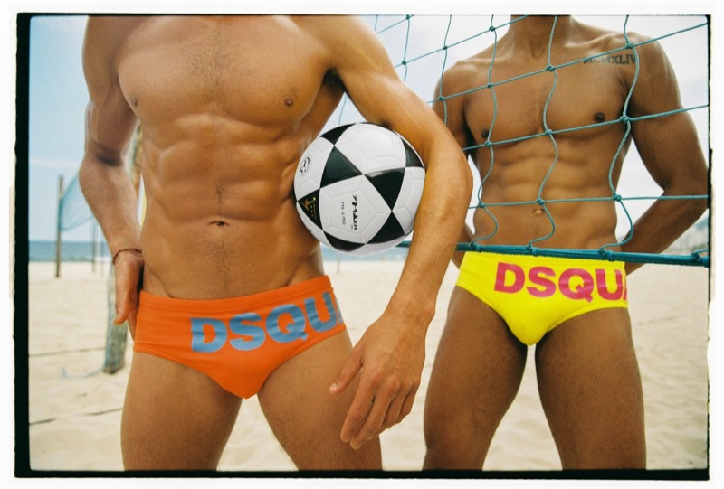 Close cropped shot of two beach volleyball players in Dsquared2 logo swim briefs