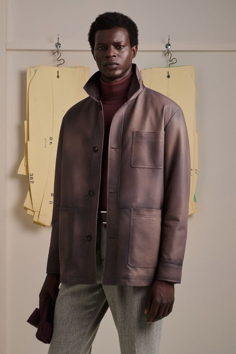 Mohammed Abubakar wears a leather field jacket over a burgundy turtleneck with gray wool trousers