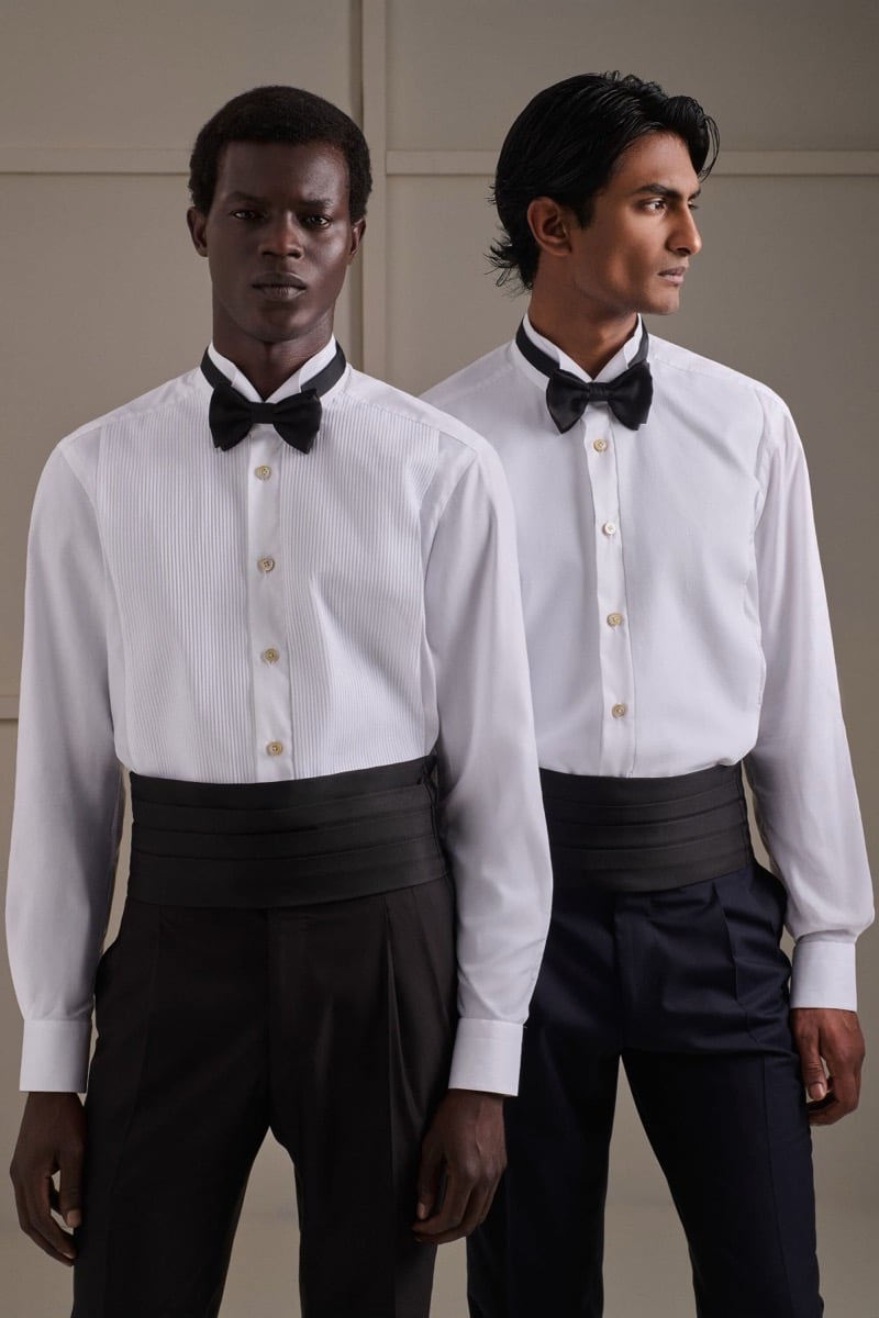 Mohammed Abubakar and Rishi Robin wear formal wing-collar tuxedo shirts with black bow ties and pleated black silk cummerbunds