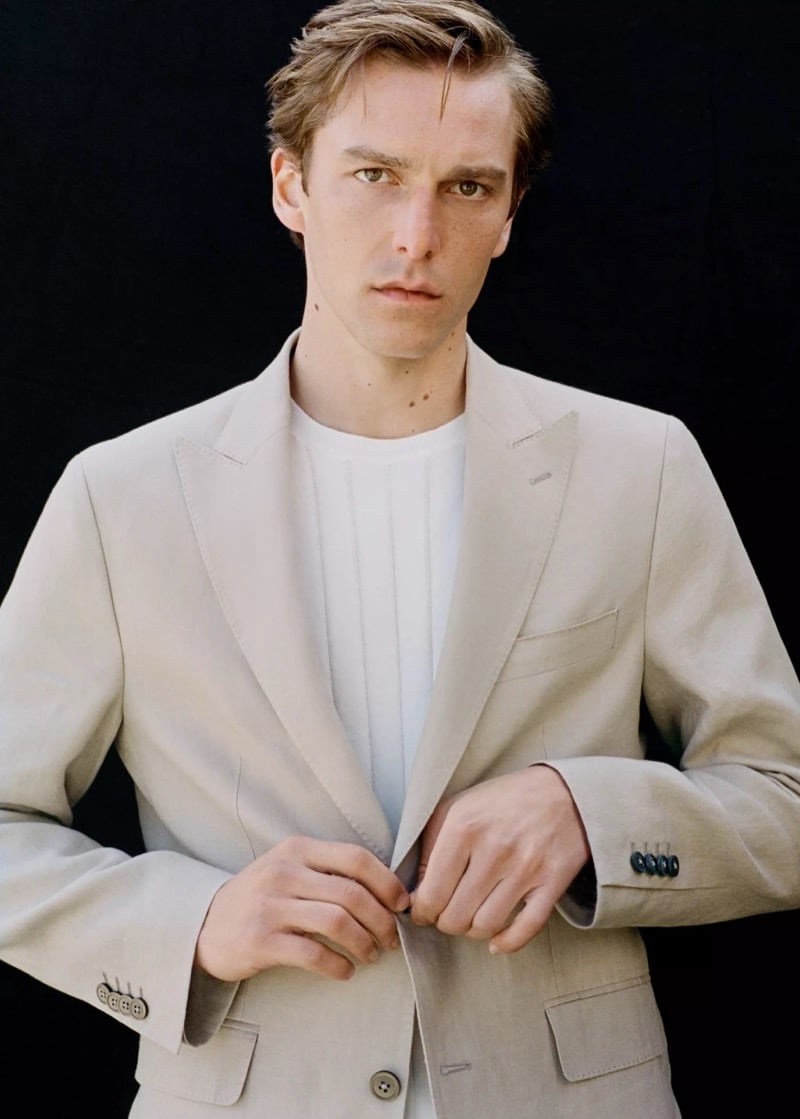Close portrait of Quentin in a beige peak-lapel linen-blend Mango blazer over a white t-shirt