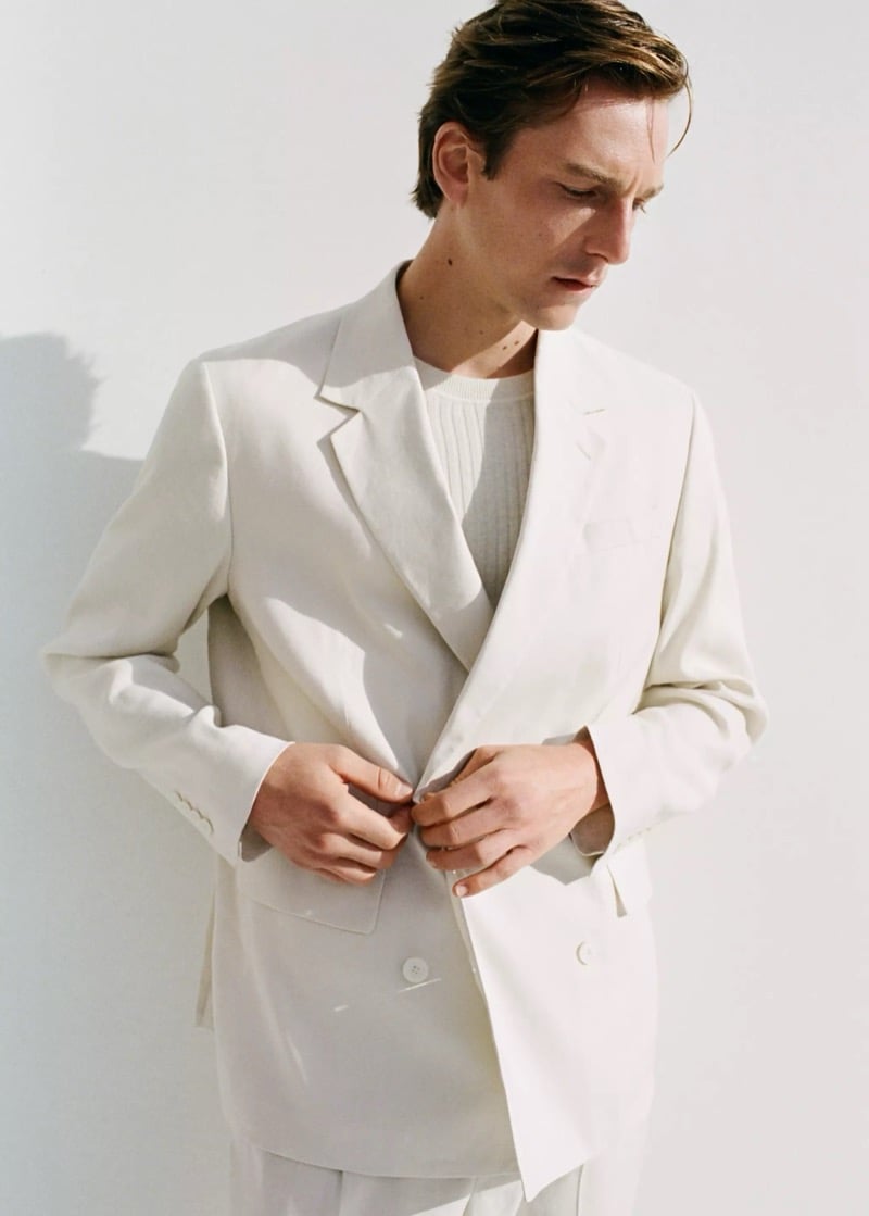 Quentin buttons a Mango cream double-breasted linen suit jacket over a white pintucked knit polo