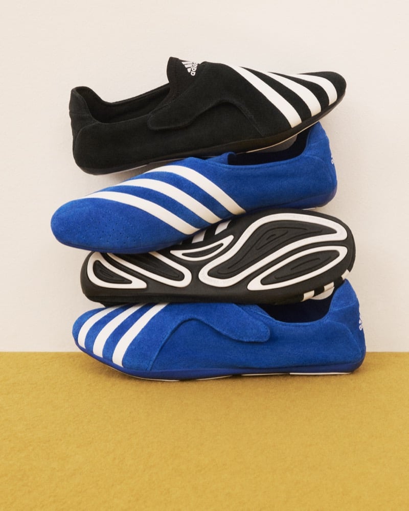 Adidas Originals Pharrell Williams Virginia Vario Flat Earther sneakers stacked in pairs of black and blue suede showing the three white stripes and sculptural rubber outsole