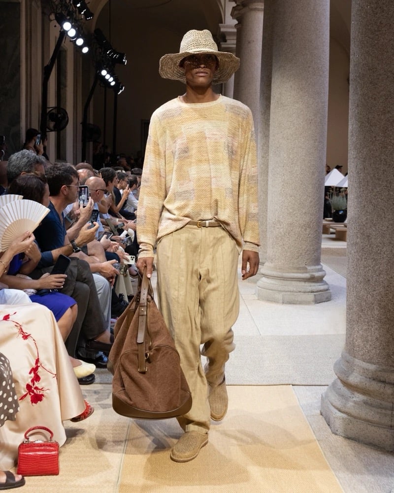 Model wears an oversized long-sleeve open-knit crewneck with a brushed mottled texture, paired with wide pleated drawstring linen trousers