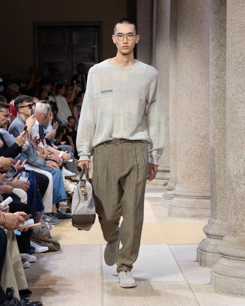 Model wears a long-sleeve textured-patchwork crewneck knit with mixed open-stitch panels, paired with wide pleated linen trousers