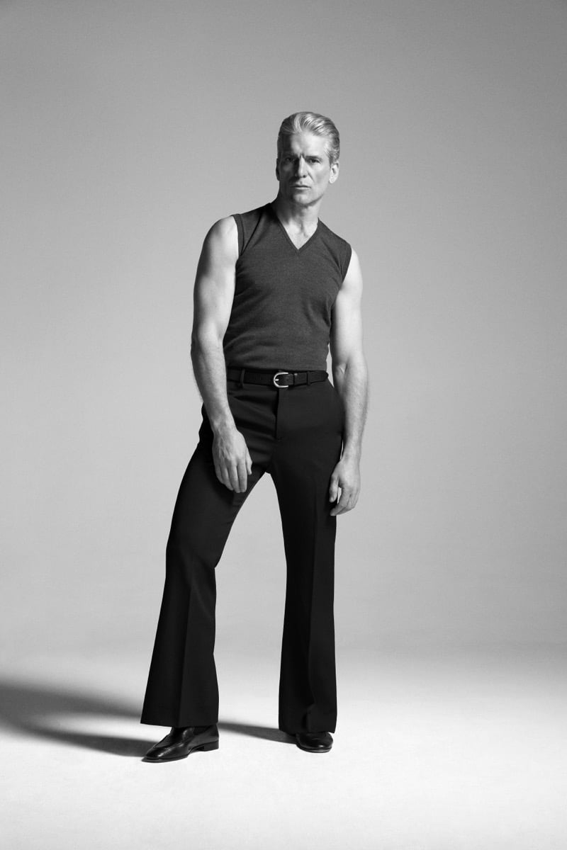 Felix Friedman models the John Smedley Hadfield extra fine merino sleeveless V-neck slipover, paired with dark flared trousers