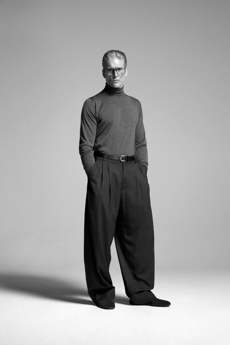 Felix Friedman wears the John Smedley Hawley extra fine merino roll neck in a heathered tone, finished with aviator-shape glasses and pleated wide-leg trousers