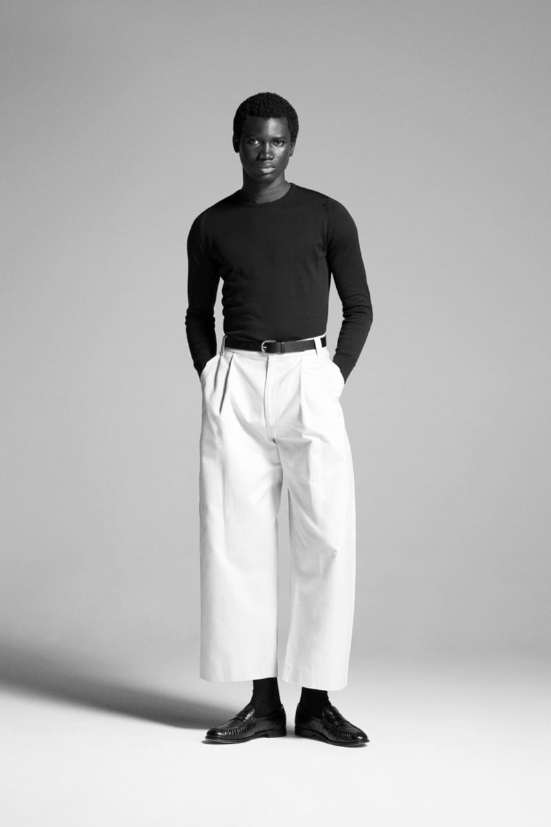 Alexander Acquah models the John Smedley Lundy extra fine merino crewneck with cropped wide-leg pleated trousers and loafers
