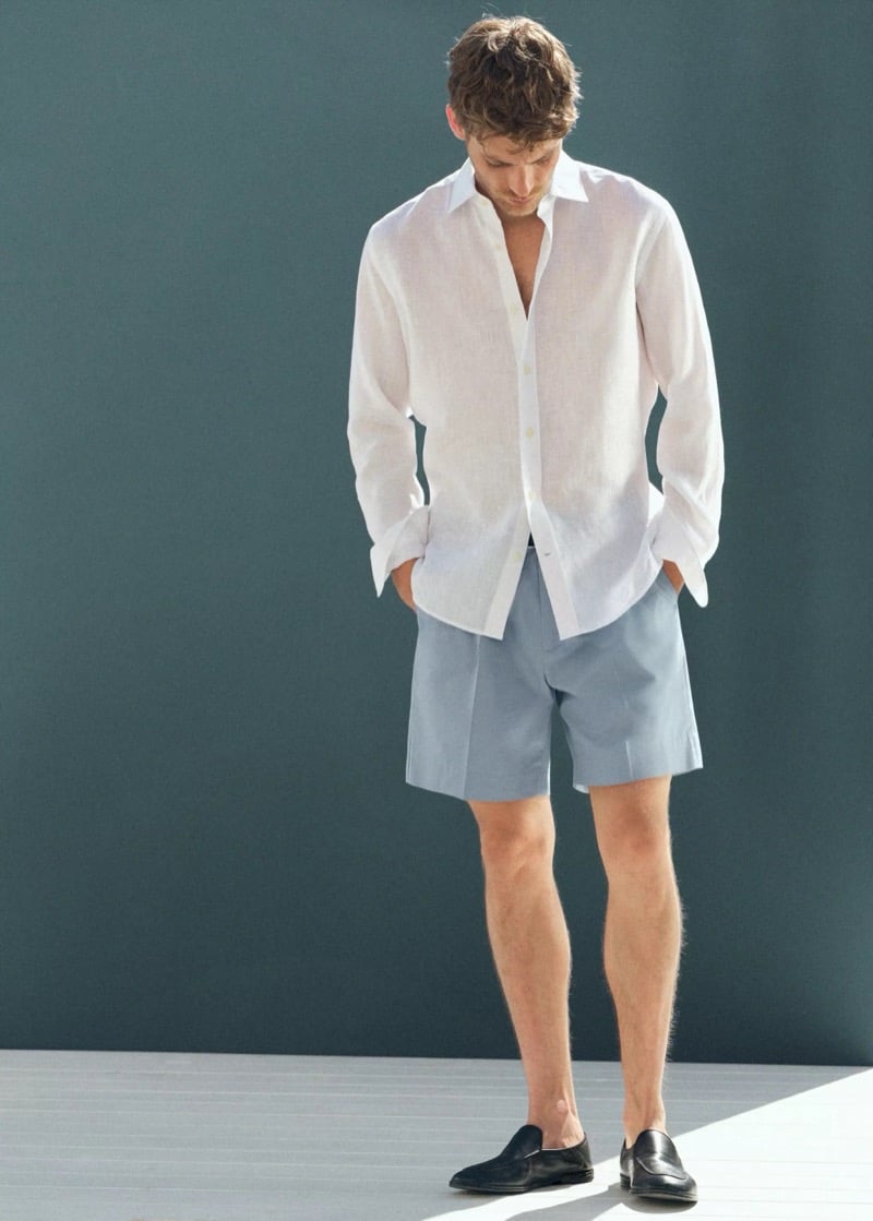Baptiste Radufe wears a white linen shirt with blue pleated tailored shorts and black loafers for Mango Man summer 2026