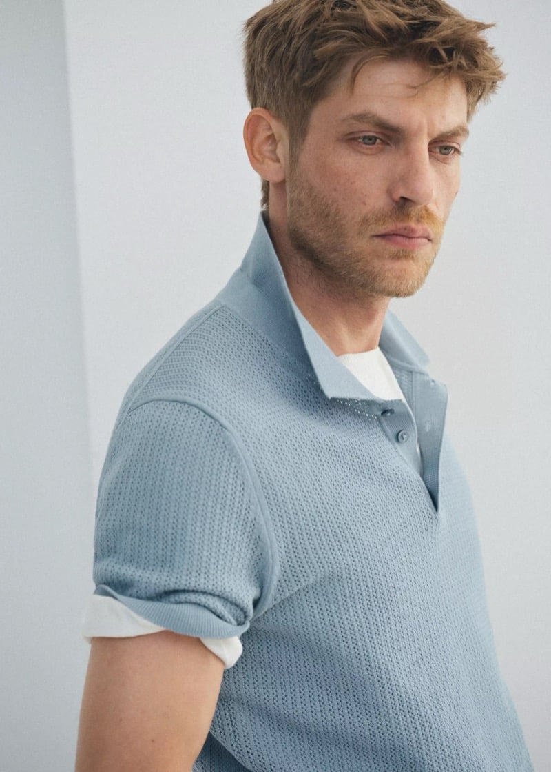 Baptiste Radufe wears a light blue open-knit polo shirt over a white T-shirt in close-up for Mango Man summer 2026