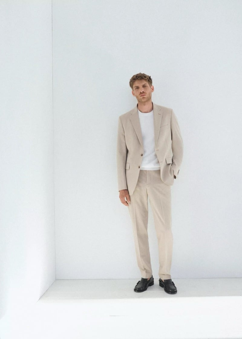 Baptiste Radufe wears a beige single-breasted tailored suit with a white T-shirt and black loafers for Mango Man summer 2026