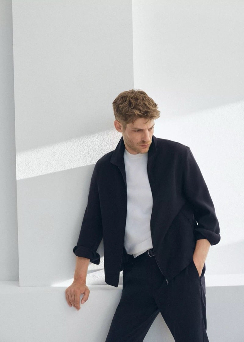 Baptiste Radufe wears a zip-front jacket with a white crew neck T-shirt and trousers for Mango Man summer 2026