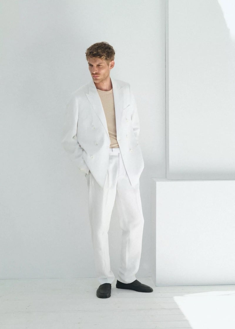Baptiste Radufe wears a white double-breasted linen suit with a cream knit tee and black leather loafers for Mango Man summer 2026