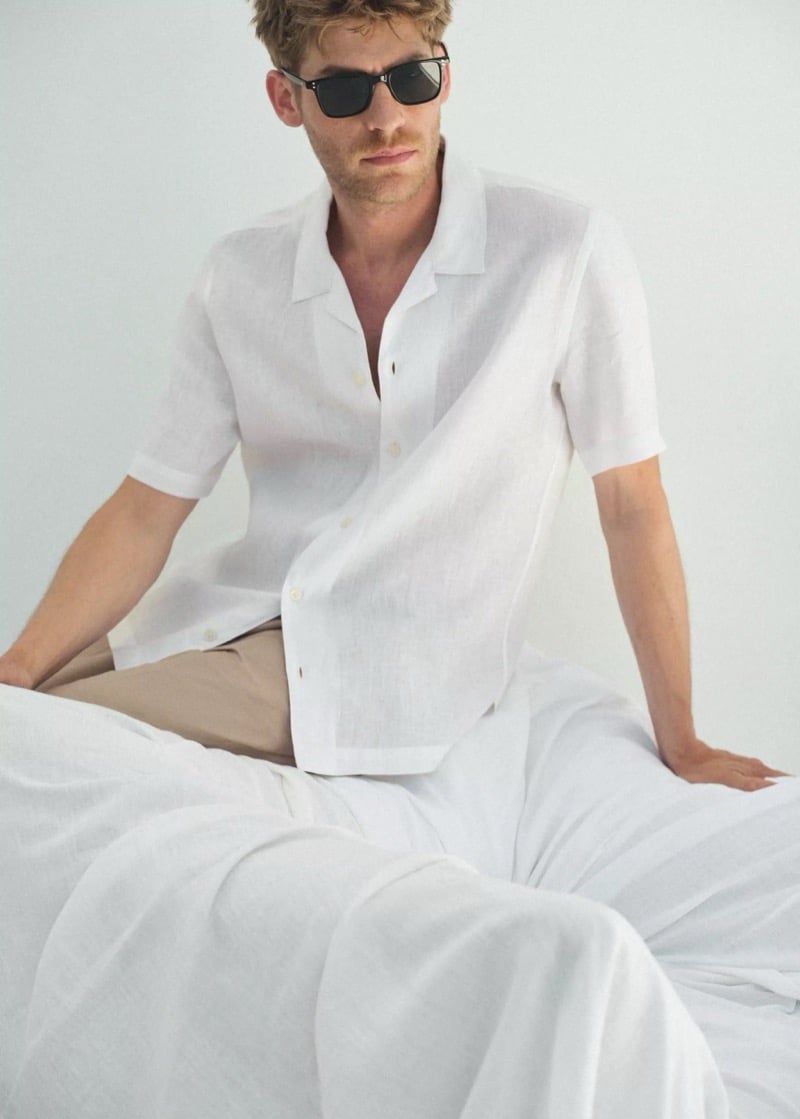Baptiste Radufe wears a white linen camp-collar shirt with tailored pants and black sunglasses for Mango Man summer 2026