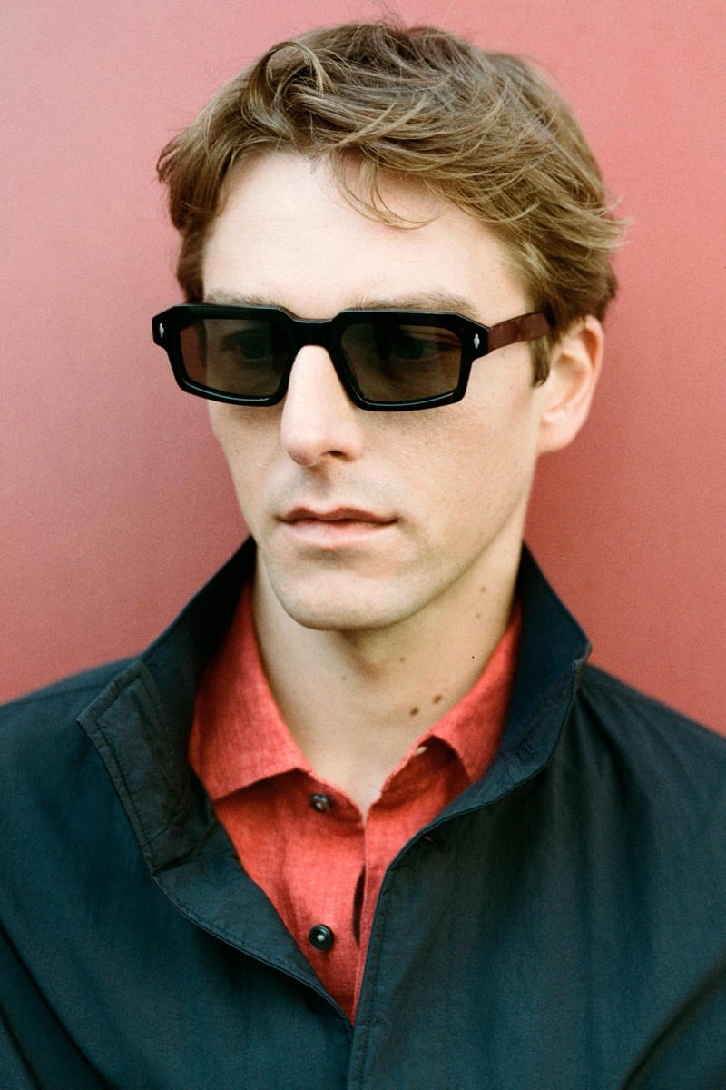 Quentin Demeester in rectangular Massimo Dutti sunglasses with an open-collar shirt layered under an overshirt