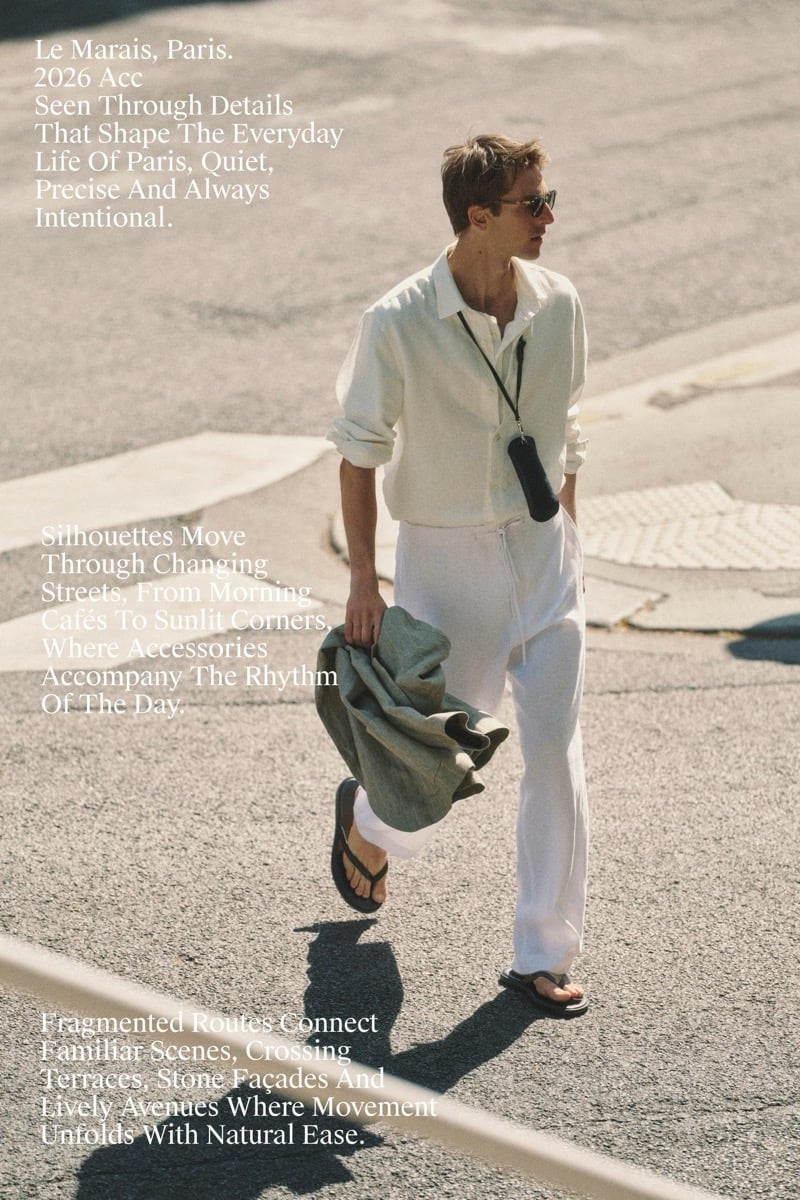 Quentin Demeester crossing a Paris street in a Massimo Dutti linen shirt and trousers with a small crossbody pouch and leather flip-flops