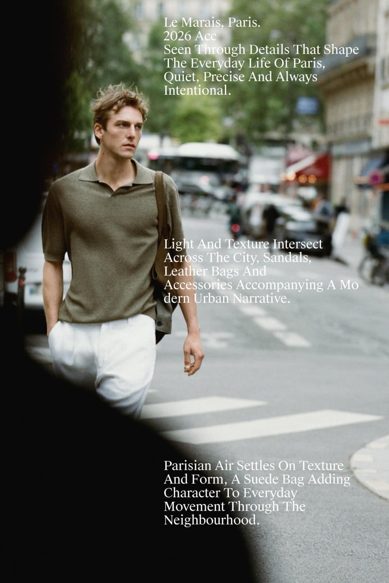 Quentin Demeester crossing a Paris boulevard in a Massimo Dutti ribbed knit polo and wide linen trousers with a suede shoulder bag