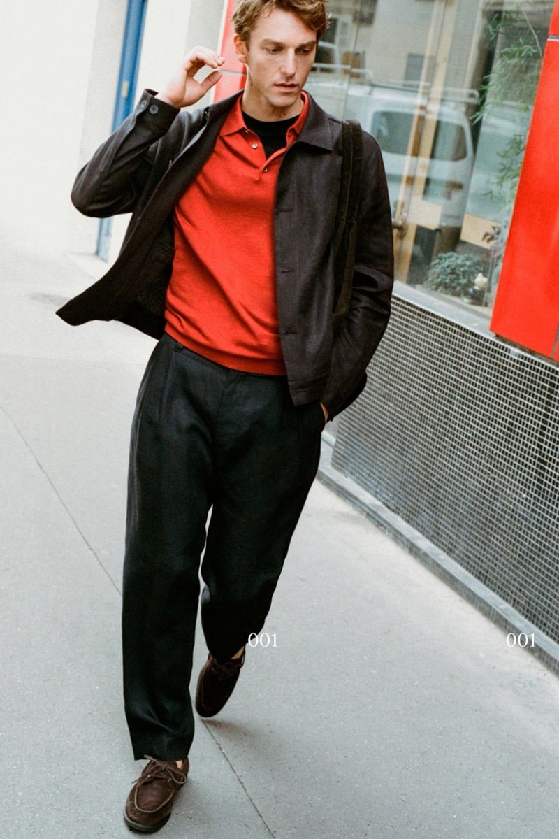 Quentin Demeester walking in a Massimo Dutti linen blouson layered over a knit polo and tee with pleated trousers and suede moccasins