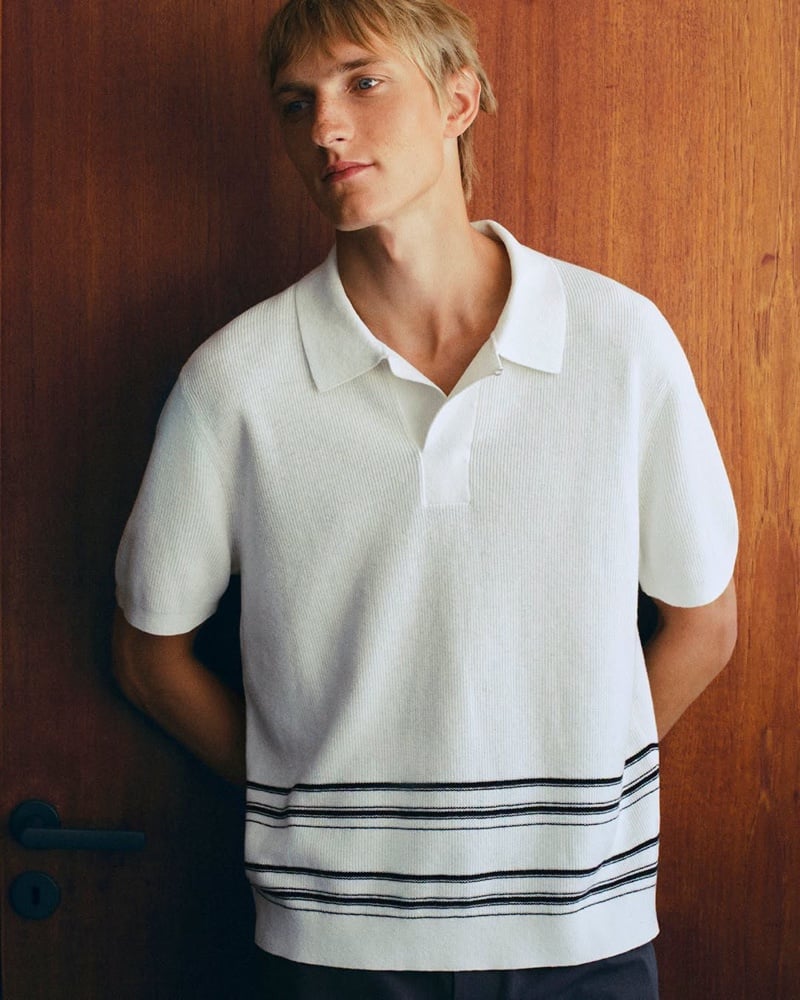 Close-up of Pierrick Grégoire in a white ribbed polo shirt with dark stripes at the hem