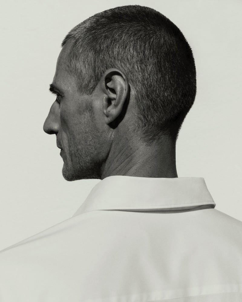 Black and white portrait of Axel Hermann from behind, showing the collar of a white shirt