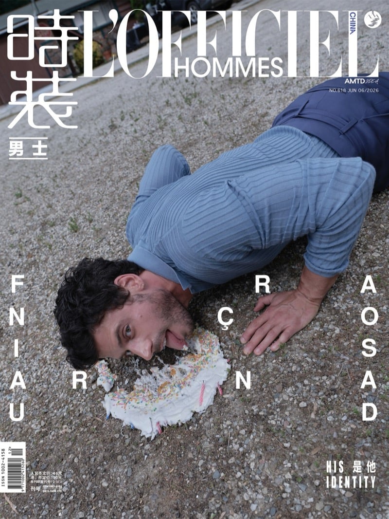 François Arnaud covers L'Officiel Hommes China face-down in a smashed birthday cake on a gravel driveway