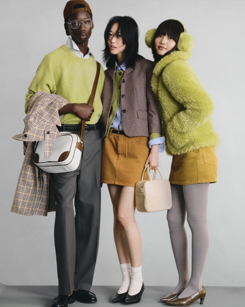 Three GU models in a lime green sweater with a plaid coat, a checked blazer with a mustard skirt, and a fuzzy lime green jacket with a mustard skirt