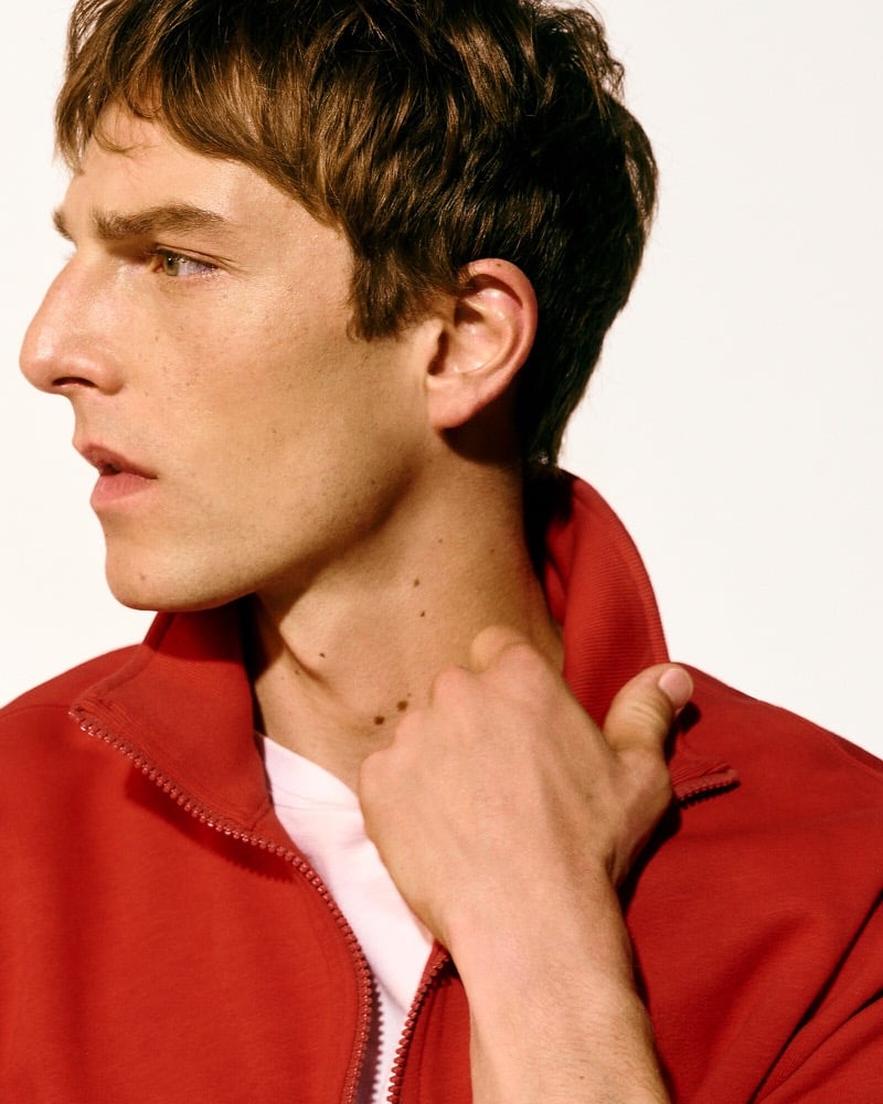 Close-up of Quentin Demeester in a red quarter-zip fleece pullover with a white T-shirt underneath
