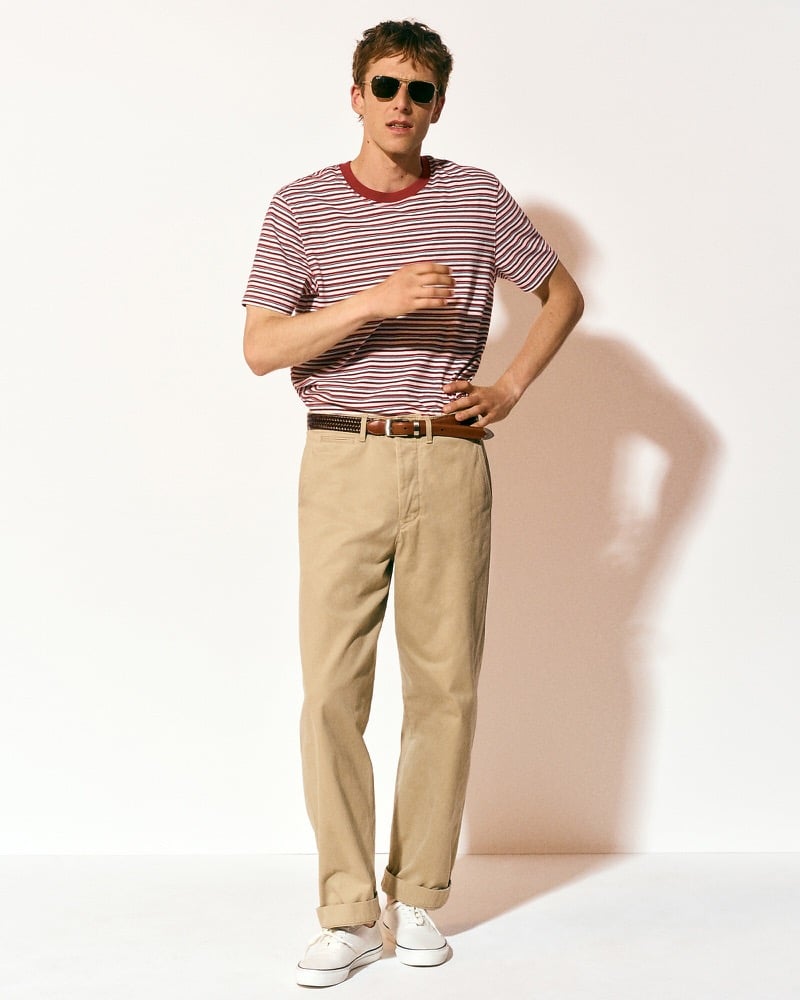 Quentin Demeester in a striped T-shirt and tan selvedge chino pants with white sneakers