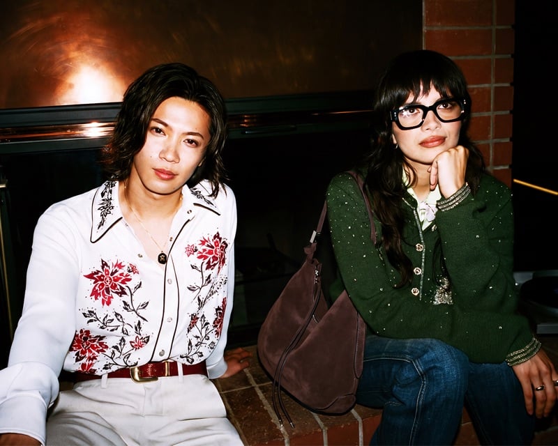 Yuta Jinguji in a floral-embroidered Western shirt sits with Bianca Lexis in a crystal-studded cardigan for AMIRI's fall-winter 2026 campaign