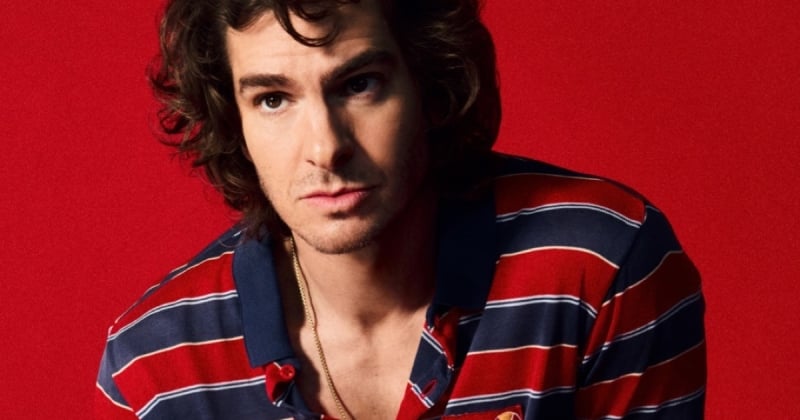 Andrew Garfield wears a red and navy striped polo shirt with a gold necklace for ellesse's 2026 campaign