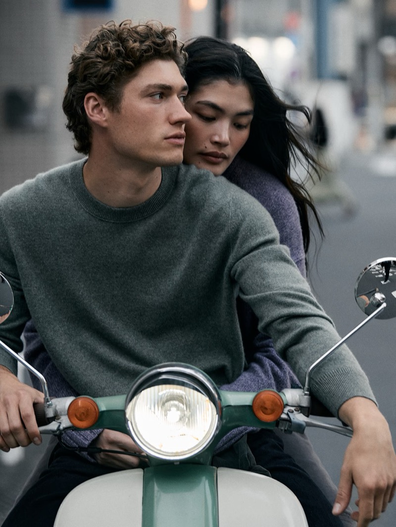 Valentin Humbroich in a gray crew-neck sweater rides a vintage scooter through Tokyo with Rina Fukushi seated behind him for Banana Republic's September 2026 edit
