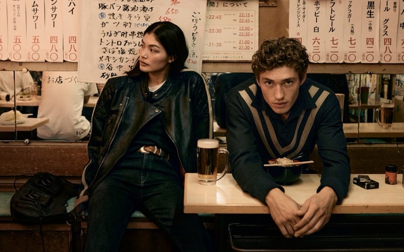 Rina Fukushi in a leather moto jacket and Valentin Humbroich in a striped knit at an izakaya counter in Tokyo for Banana Republic's September 2026 edit
