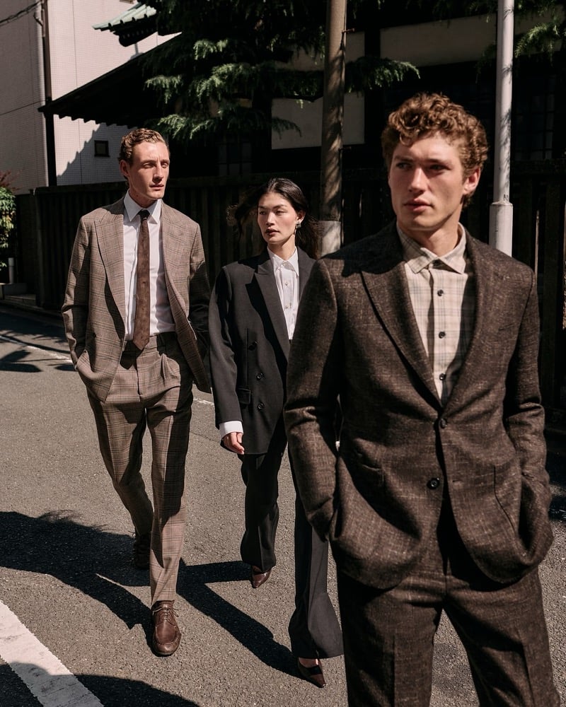 Aubrey O'Mahony, Rina Fukushi, and Valentin Humbroich walk a sunlit Tokyo side street in brown and tan tailoring for Banana Republic's September 2026 edit