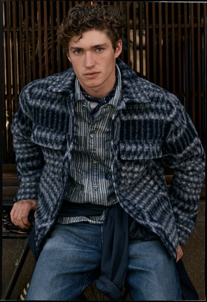 Valentin Humbroich wears a blue checked wool overshirt over a striped shirt with jeans for Banana Republic's September 2026 edit