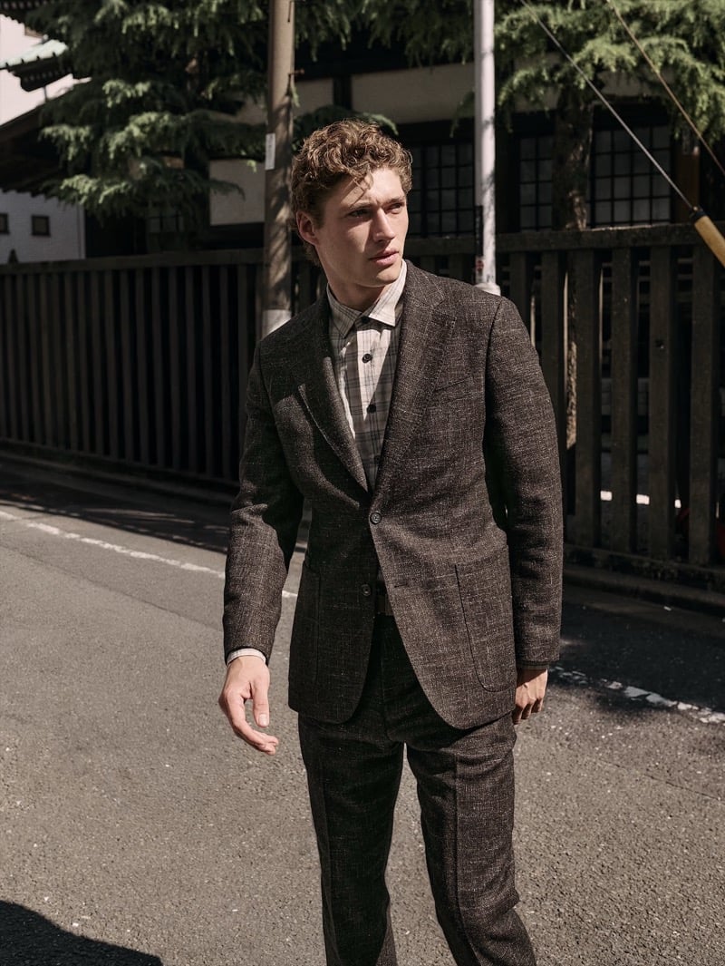 Valentin Humbroich walks a Tokyo street in a brown donegal tweed suit over a checked shirt for Banana Republic's September 2026 edit