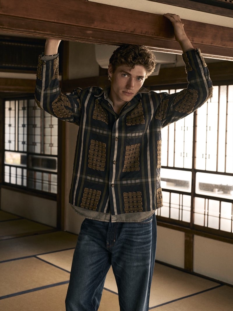 Valentin Humbroich in a dark patchwork-plaid camp-collar shirt and loose jeans in a tatami-floored room for Banana Republic's September 2026 edit