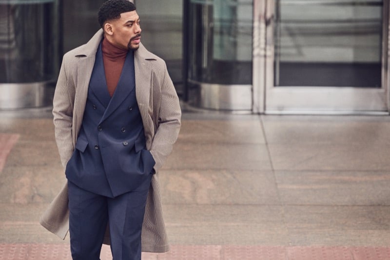 Aaron Pierre wears a houndstooth overcoat over a double-breasted suit and rust turtleneck for BOSS's fall-winter 2026 campaign